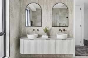 Contemporary bathroom interior with twin arched mirrors