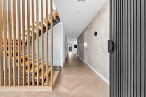 Architectural interior with timber staircase and textured walls