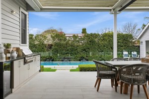 Outdoor living area overlooking a landscaped pool in Surrey Hills