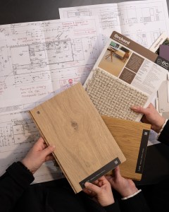 Timber flooring and carpet samples arranged over construction drawings for the TimTek showroom