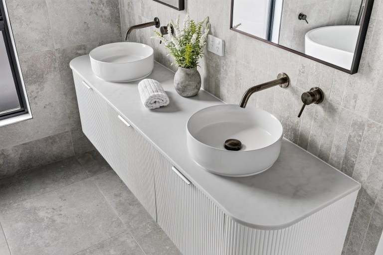 Double vanity with round basins and textured cabinetry in the New Alia Home build