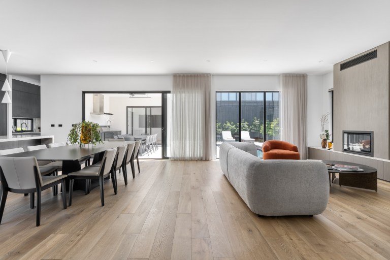 Open-plan dining and living area with pool outlook in the New Alia Home build in Balwyn