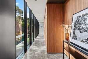 Timber-lined hallway beside full-height glazing at 1 Carrigal Street
