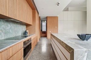 Galley kitchen with timber cabinetry and stone surfaces at 1 Carrigal Street