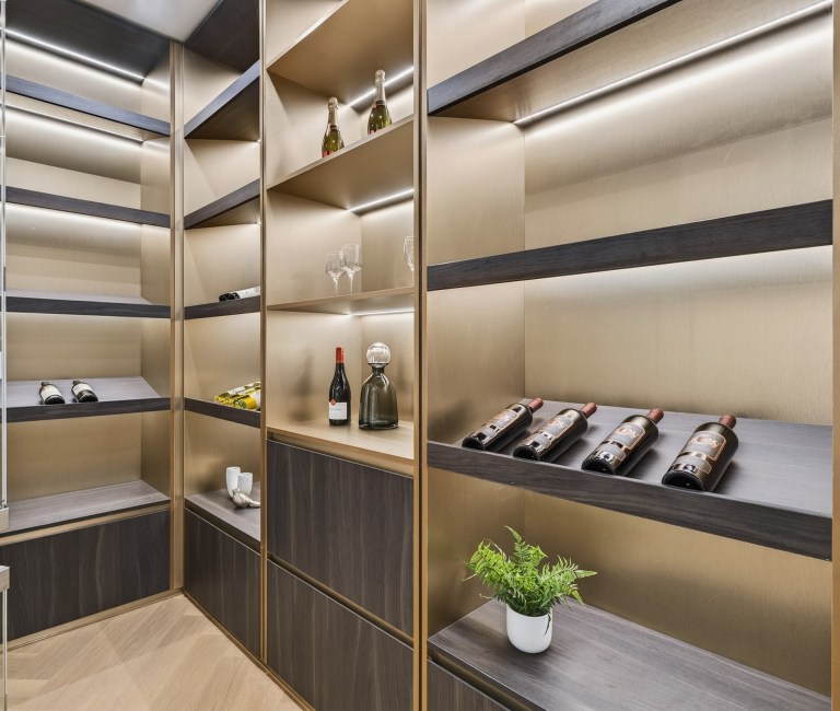 Illuminated custom wine storage with bronze cabinetry in Doncaster