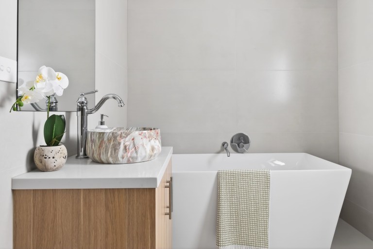 Contemporary bathroom with a freestanding bath and marble vessel basin in Doncaster East